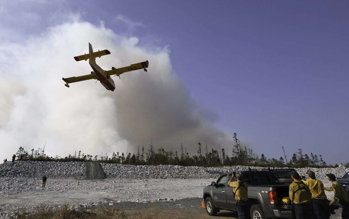A water bomber make a pass over the wildfire.