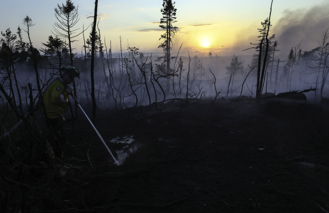 A firefighter battles the wildfire.