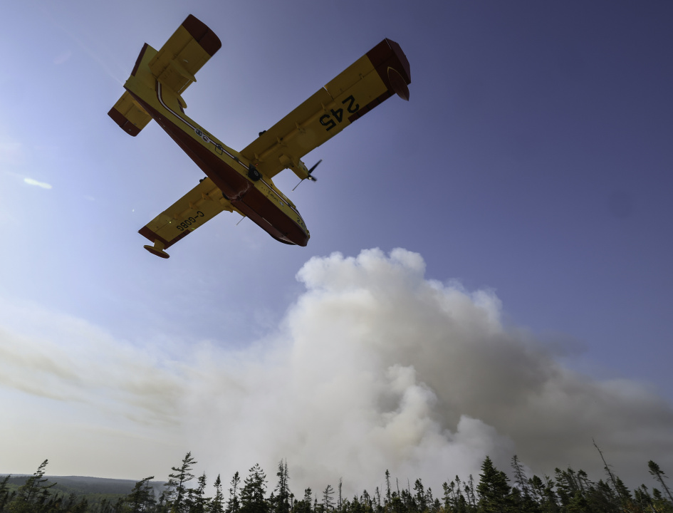 A water bomber make a pass over the wildfire.
