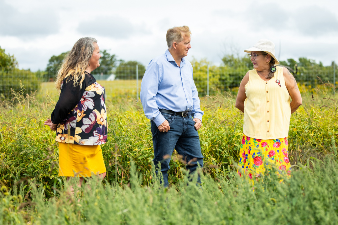 Scott Armstrong, Minister of Opportunities and Social Development, with others at the Colchester Food Network's community garden.