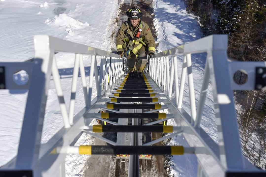 A firefighter on a ladder.