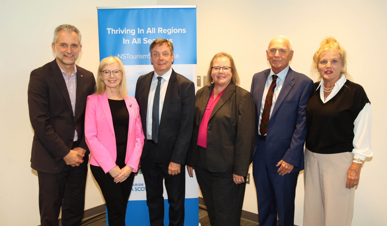 Six people posing for a photo after an announcement