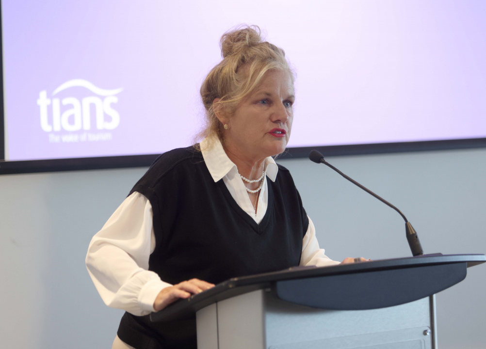 Darlene Grant Fiander – Tourism Industry Association of Nova Scotia (TIANS) President and Nova Scotia Tourism Human Resource Council (NSTHRC) Executive Director at a podium