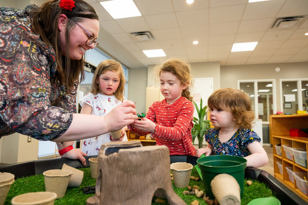 Three children and an early childhood educator at a daycare