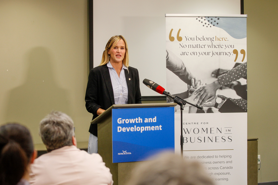 Minister Leah Martin at a podium