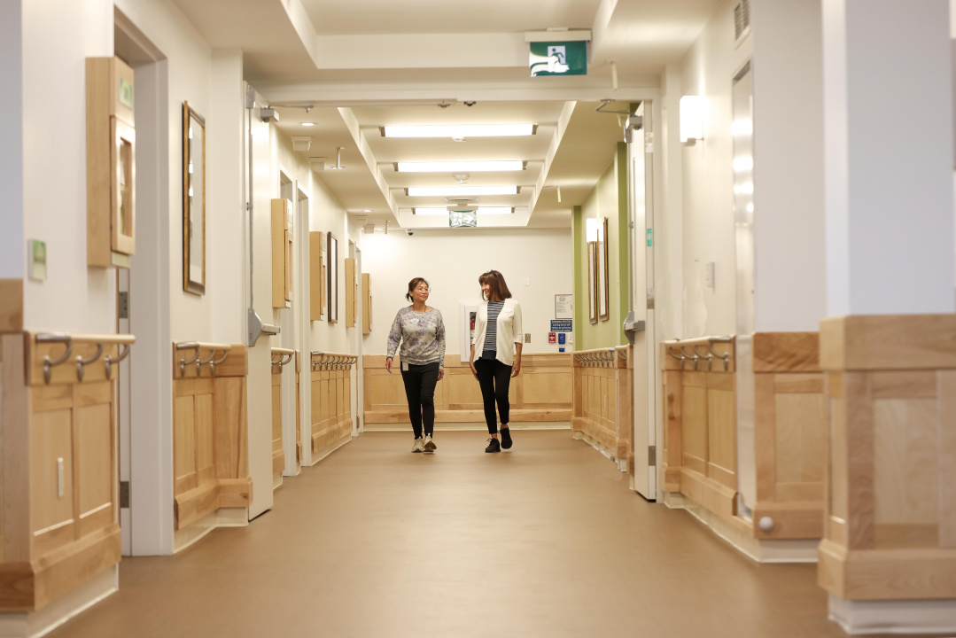 Two people in a hall of a long-term care home