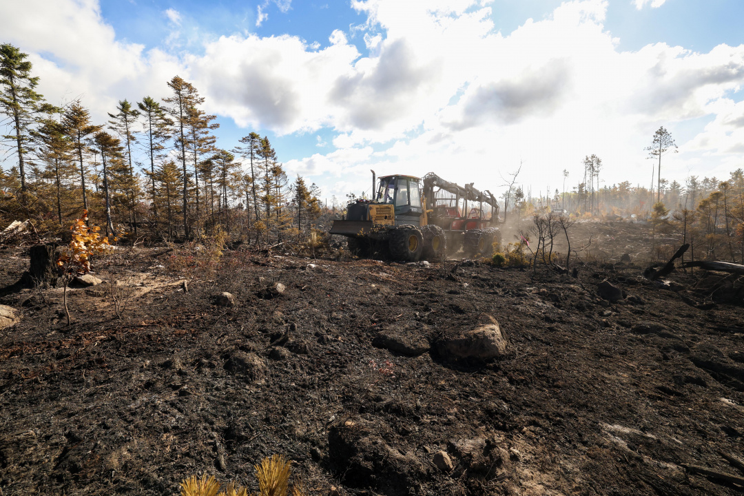 Heavy equipment operator Kent Eisner from Bridgewater brings in supplies for crews making the fire breaks. 