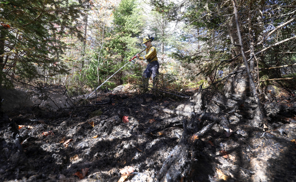 DNR firefighter Garson Grady works on some hotspots at the Lake George fire