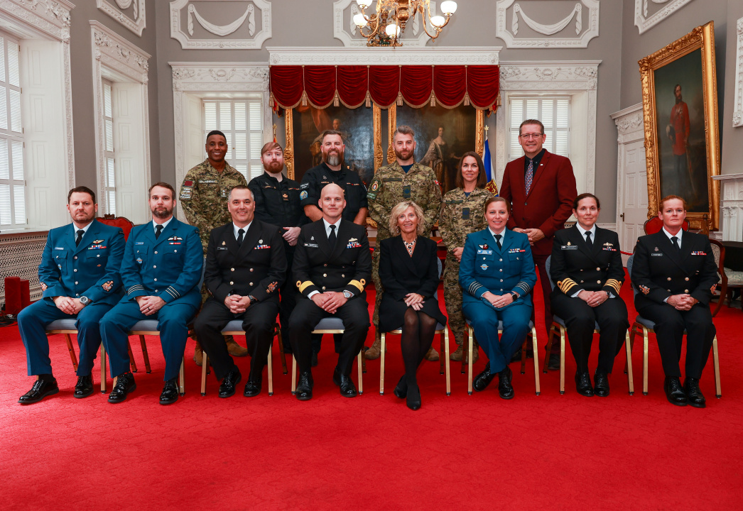 Members of the military join Barbara Adams, Minister responsible for Military Relations, and Ministerial Assistant Chris Palmer in the Red Chamber