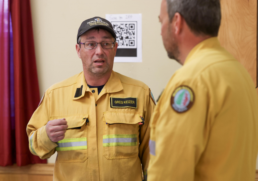 Greg Keizer, Safety Officer, and James McKinnon, Incident Commander, discuss today's operations at the Morristown Community Centre.