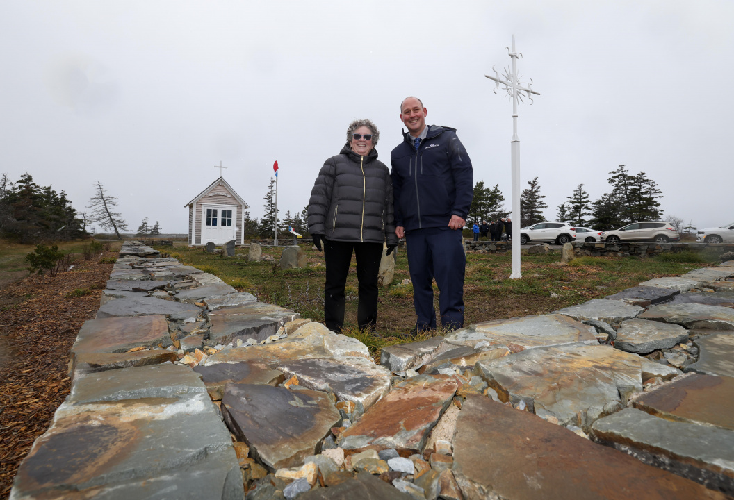 Environment and Climate Change Minister Timothy Halman and another person standing in an old cemetery
