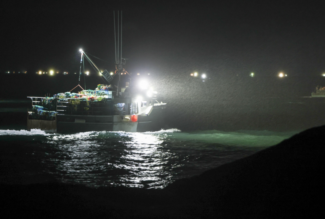 A ships light illuminated the rain showers as it rounds Cape Forchu, Yarmouth County.