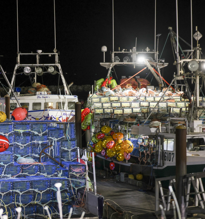 Lobster boats loaded with traps at a wharf