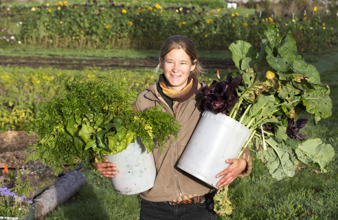 A women holding produce in pots