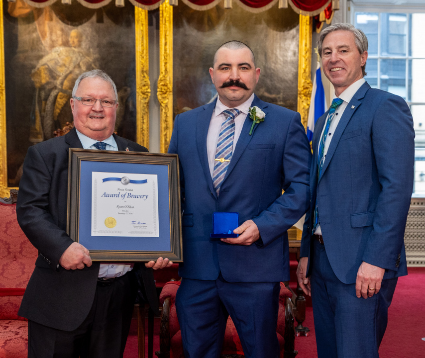 L-R: Tom Steele, Chair, Medal of Bravery Advisory Committee; medal recipient Ryan O'Shea of Sydney; and Premier Tim Houston