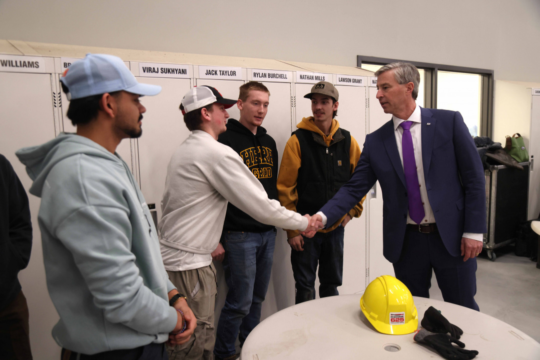 Premier Tim Houston shakes hands with a student