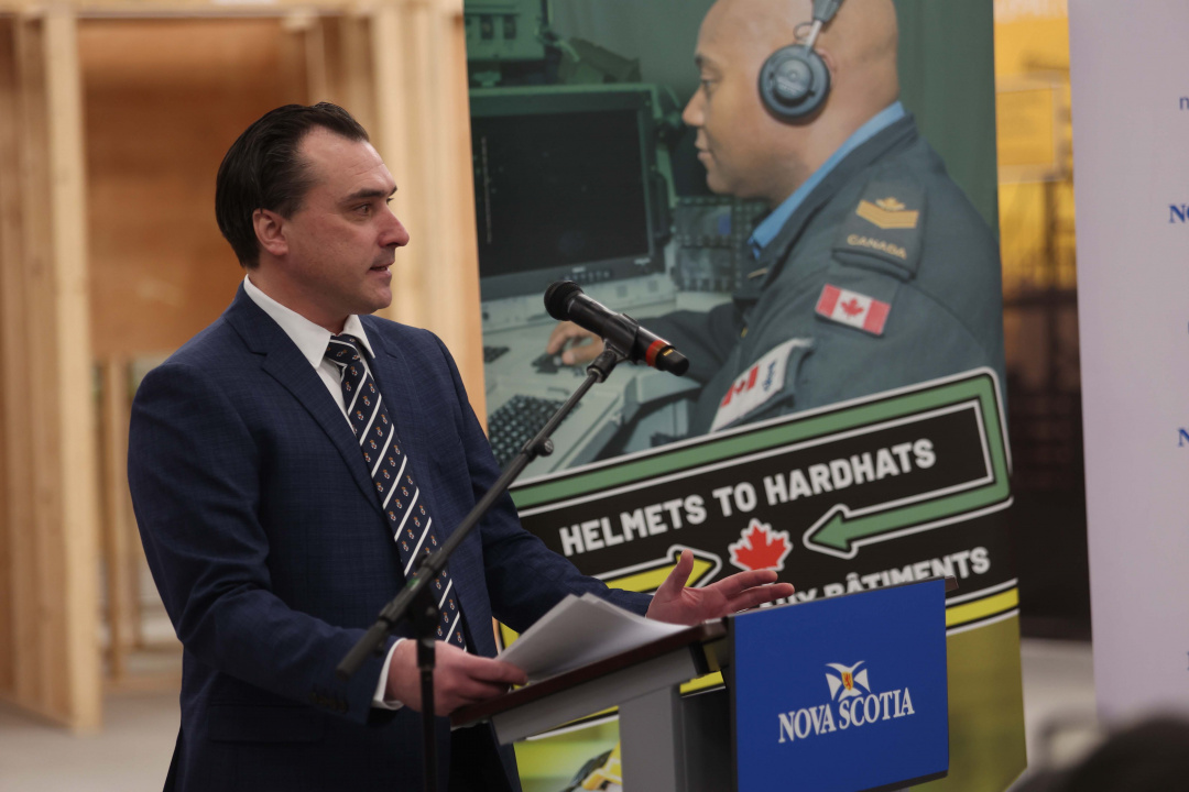 Nolan Young, Minister of Labour, Skills and Immigration at a podium