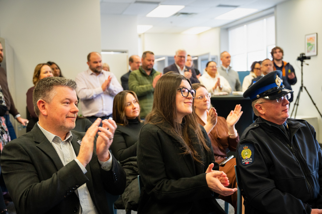 People clapping at a provincial-federal announcement