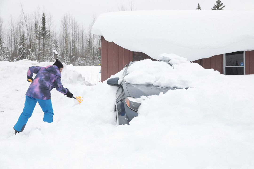 A person shovels snow.