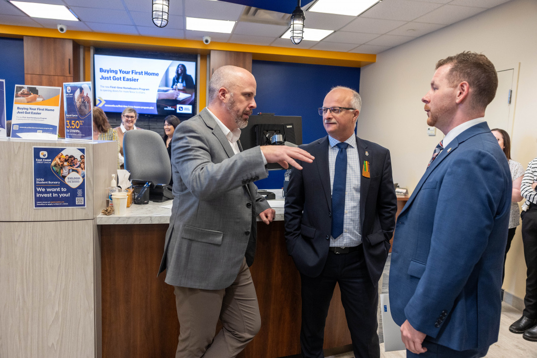 Dan Roberts, Director, Retail Banking and Member Experience, East Coast Credit Union, speaks with John White, Minister of Housing and Colton LeBlanc, Minister of Growth and Development