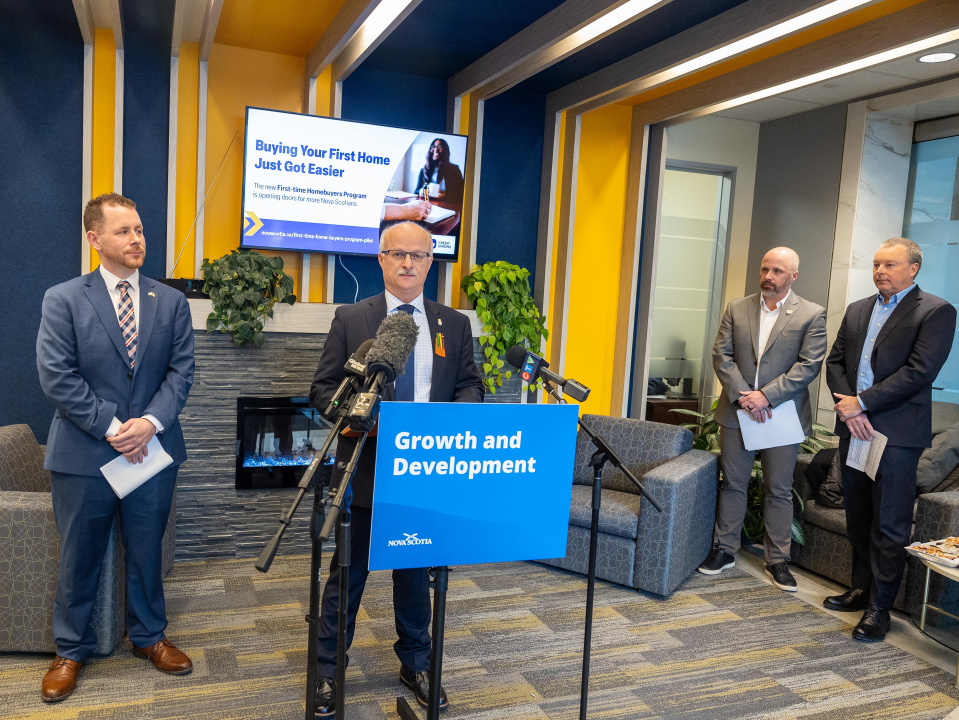 Housing Minister John White at a podium