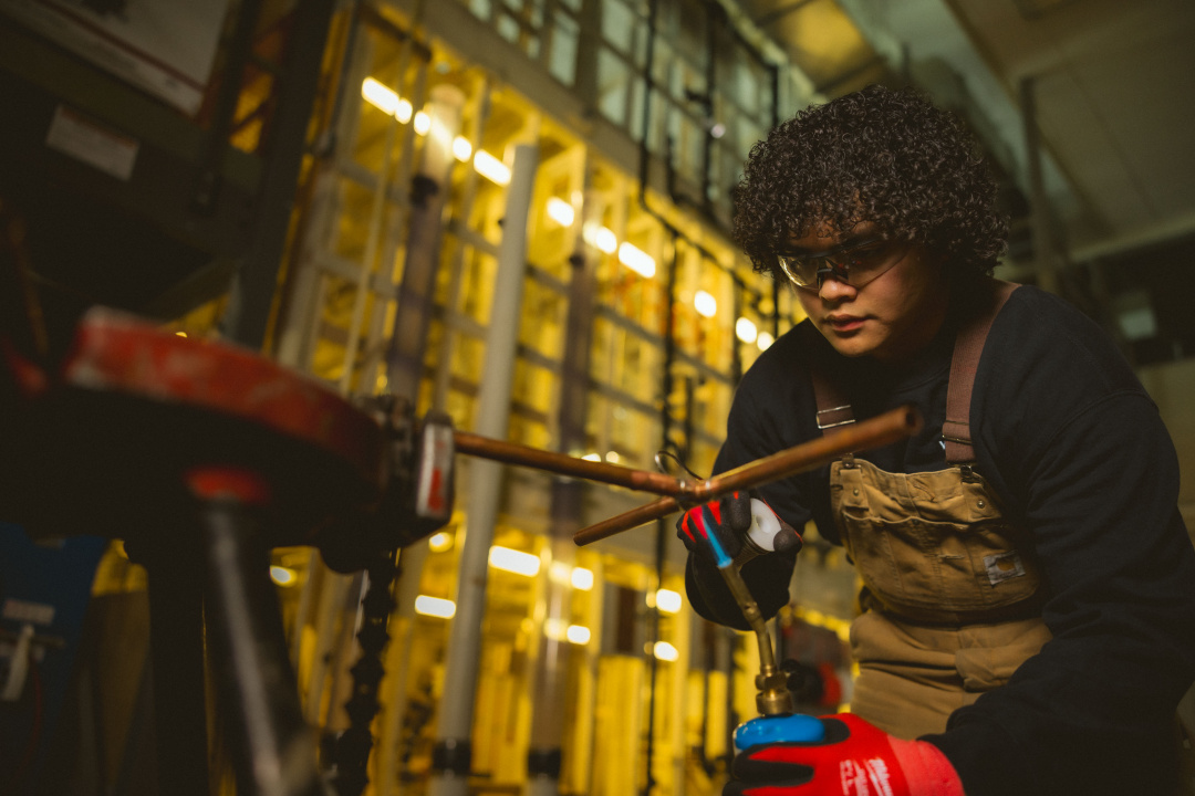 A plumbing student at work.