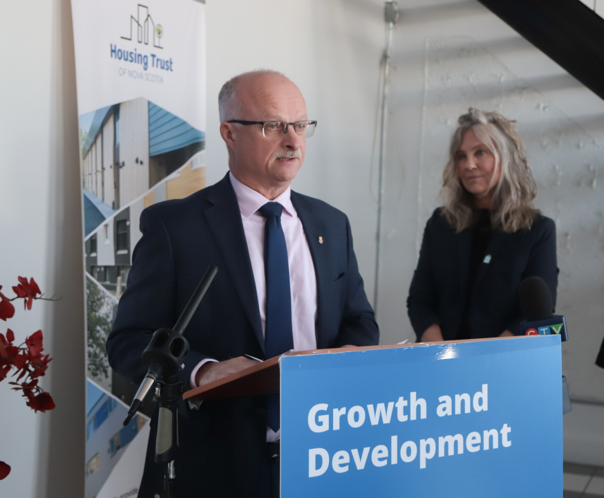 Housing Minister John White at a podium