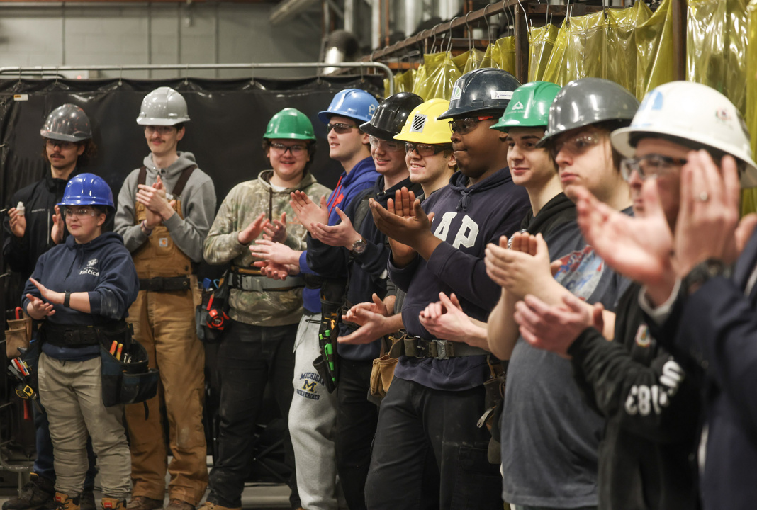 Students in the NSCC carpentry program applaud the announcement.