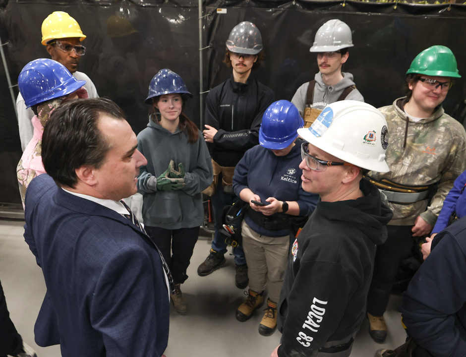 Nolan Young, Minister of Labour, Skills and Immigration, left, speaks with Aaron Cathcart, a member of the NSCC carpentry faculty, with students.