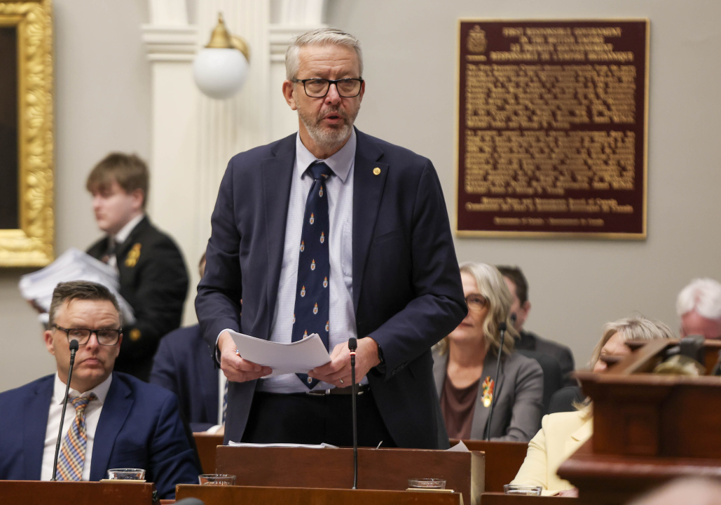 Finance and Treasury Board Minister John Lohr standing in the legislative assembly