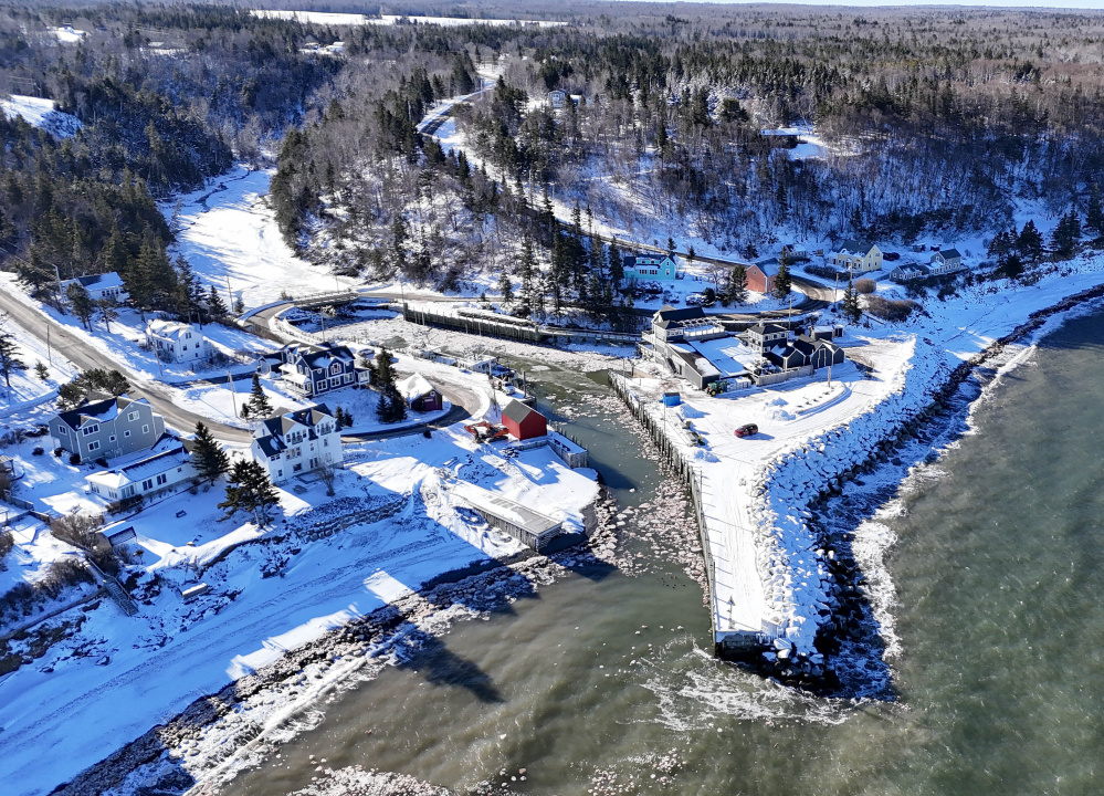 An aerial view showing the harbour, wharf and nearby buildings. 