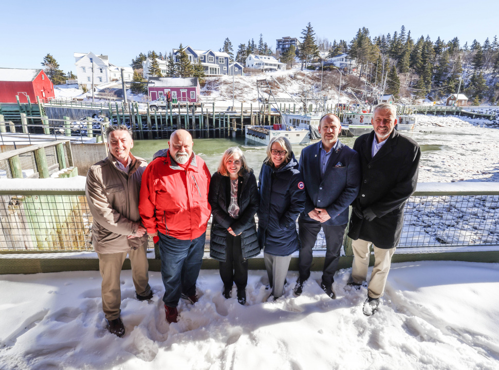 From left, Bernard Miles, Chair, Halls Harbour Community Development Association; Dave Corkum, Mayor, Municipality of the County of Kings; Juanita Spencer, CEO, Nova Scotia Federation of Municipalities; Melissa Sheehy-Richard, Ministerial Assistant to the Minister of Environment and Climate Change; Robbie Hiltz, Councillor, Municipality of the County of Kings; and Finance and Treasury Board Minister John Lohr, MLA for Kings North, in front of the Halls Harbour wharf. 