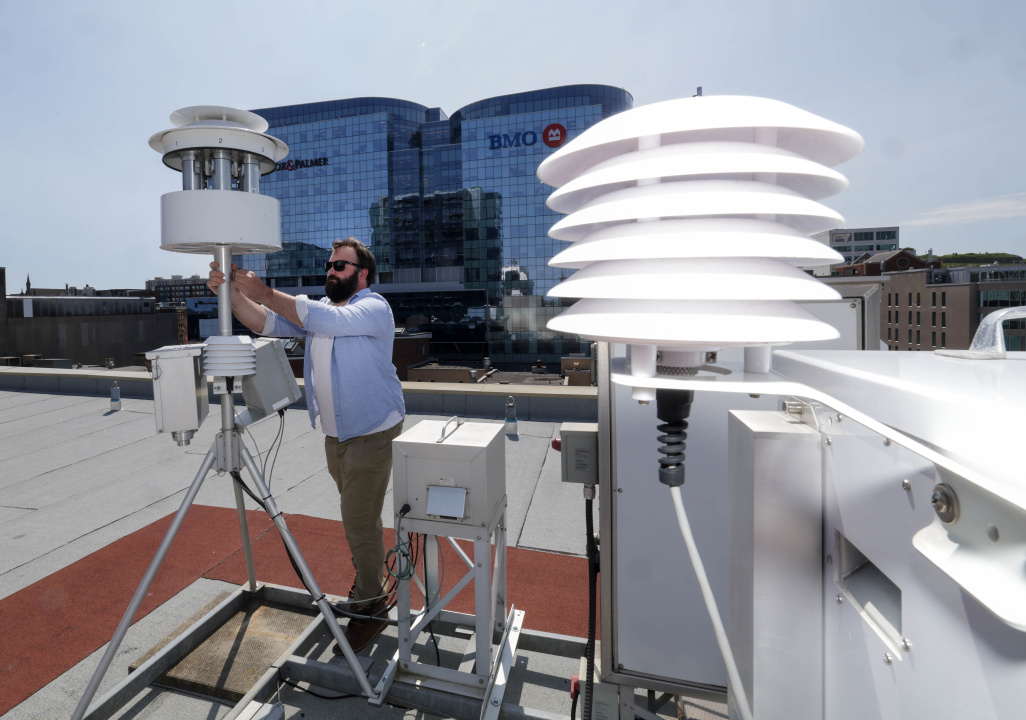 A technician checks an air quality monitoring station atop a building in downtown Halifax.