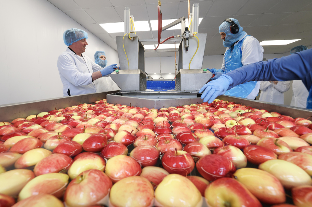Greg Morrow, Minister of Agriculture, tries out the assembly line.