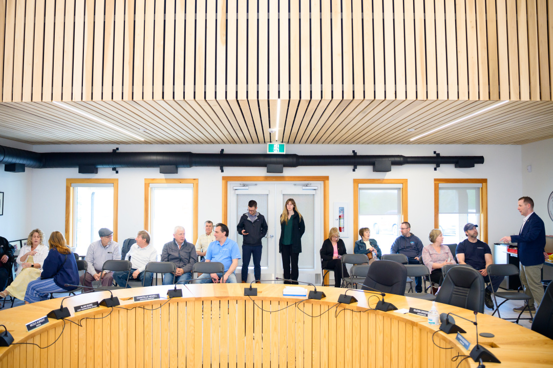 People in a municipal council chamber