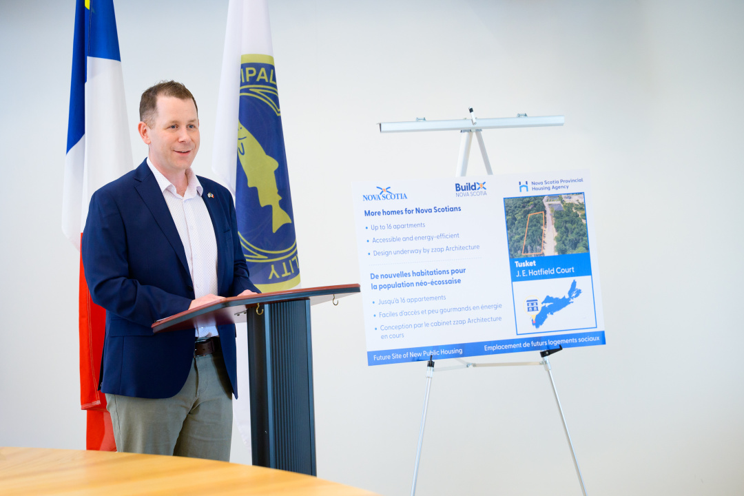 Growth and Development Minister Colton LeBlanc at a podium 