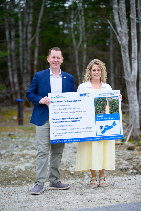 Growth and Development Minister Colton LeBlanc and Argyle Municipal Warden Nicole Albright stand outside holding a sign about new public housing