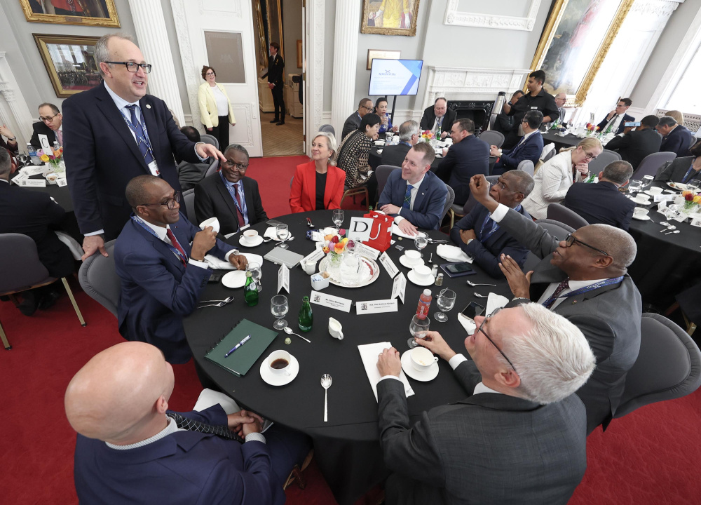 Sebastien Carriere, Chief of Protocol, Global Affairs (left) speaks to delegates during a networking lunch in Province House's Red Chamber.