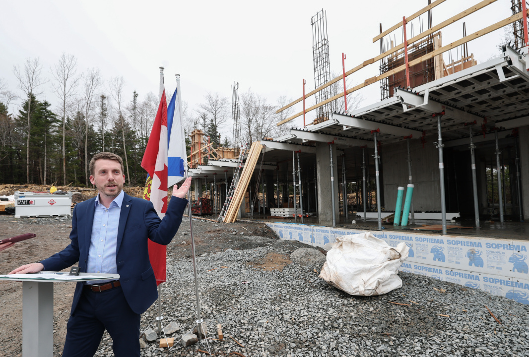 Braedon Clark, MP for Sackville-Bedford-Preston, announcing a new child-care centre under construction un the background in Beaver Bank 