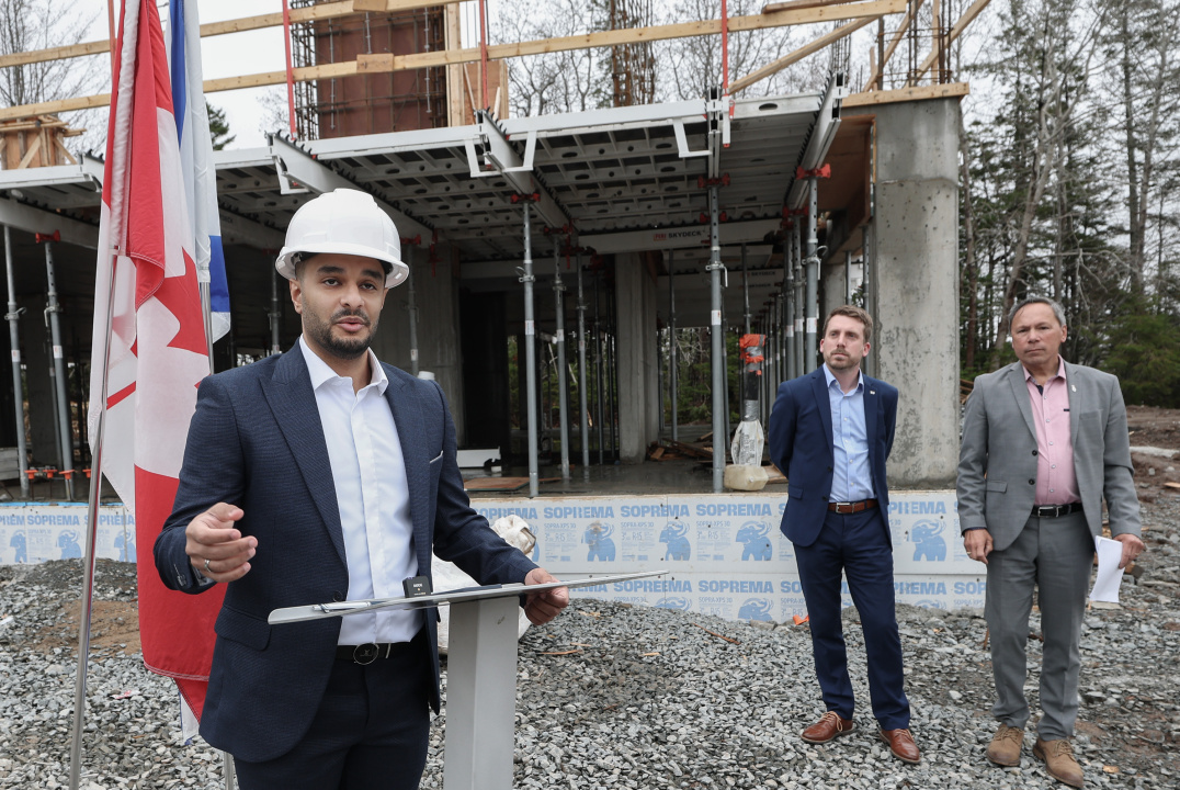 Mehrad Mohammadkhani, Executive Director of It Takes a Village Daycare Society, speaks in front of a child-care centre under construction