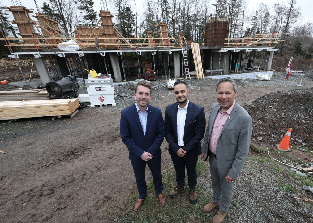 Braedon Clark, Mehrad Mohammadkhani and Brian Wong stand in front of the new child-care centre, currently under construction in Beaver Bank