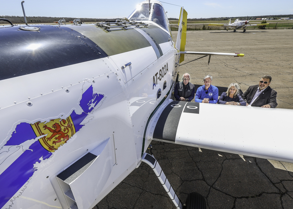Premier Tim Houston and others with one of the new planes.