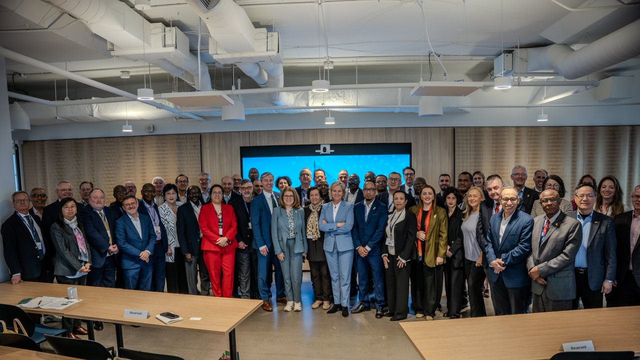 Premier Tim Houston stands with ambassadors and high commissioners (heads of state) representing 46 countries on their visit to the Nova Scotia Health Innovation Hub in Halifax. 