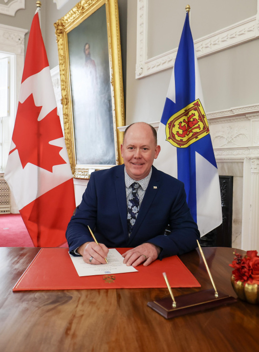 Tory Rushton signing a document