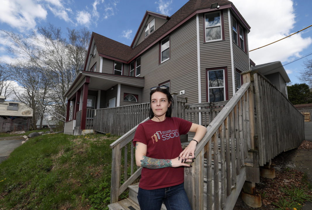 A woman standing outside a house