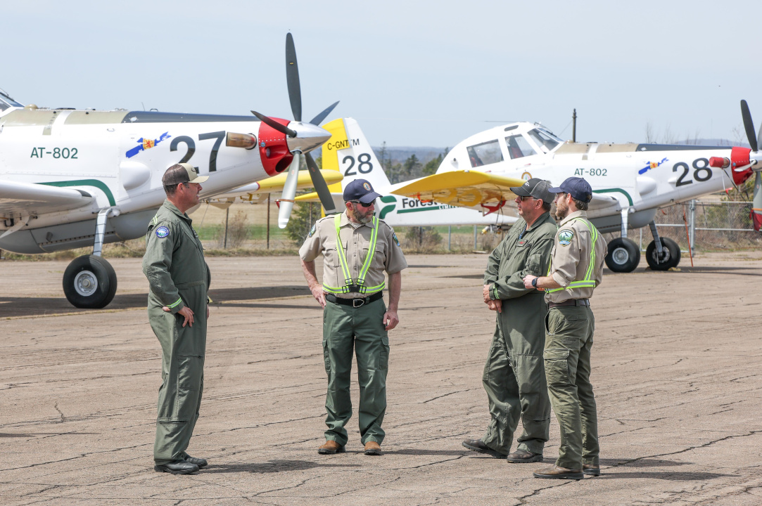 Four crew members in front of aircraft.