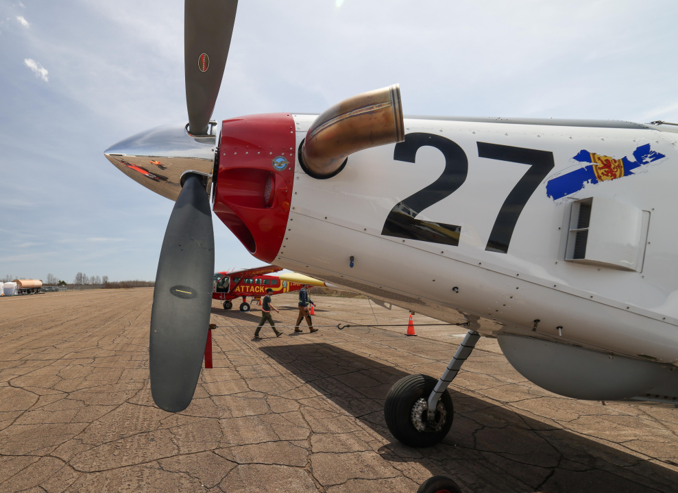 An Air Tractor AT-802 in front of a Cessna Caravan Bird Dog plane.