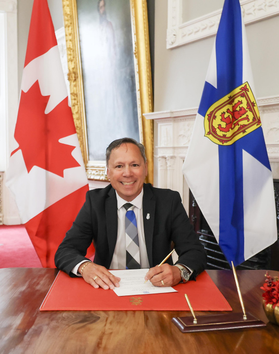 Brian Wong signing a document