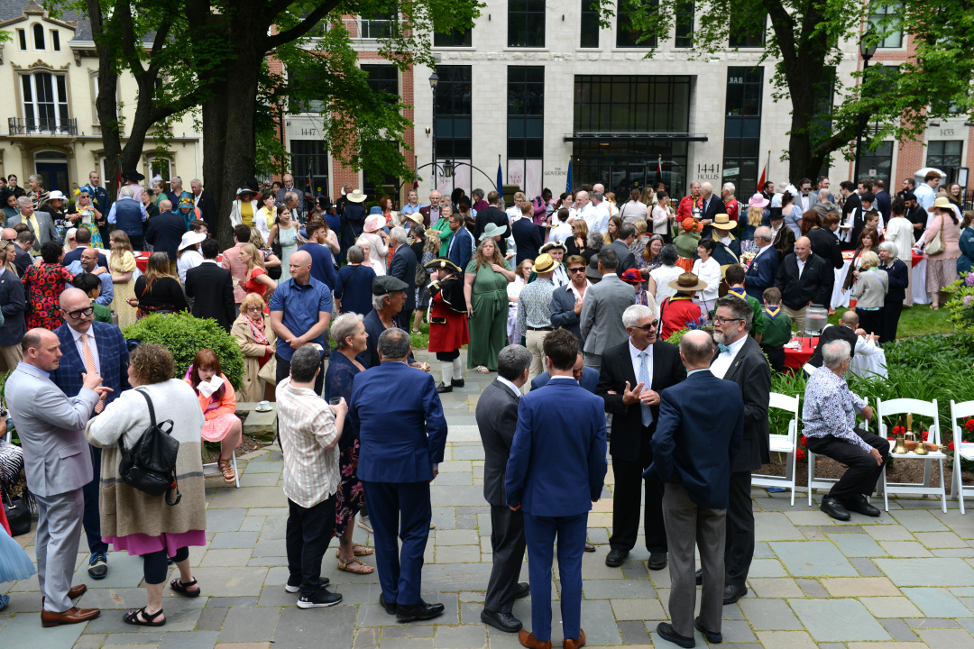 Attendees mill about during the 2025 garden party.