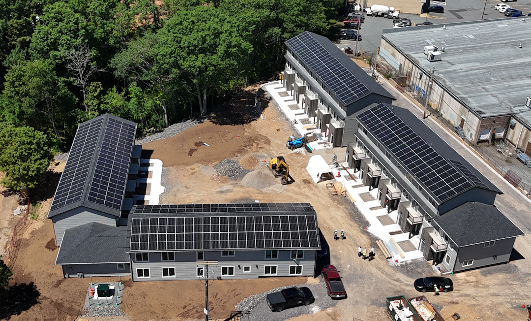 Aerial photo of buildings with solar panels on their roofs